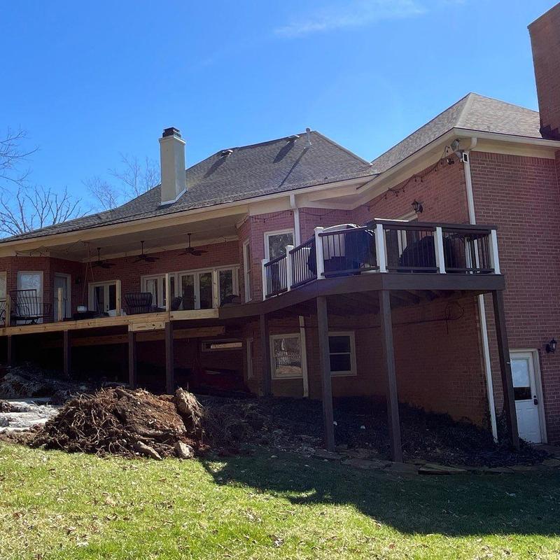 Asphalt shingle roof with hail damage and deck railing