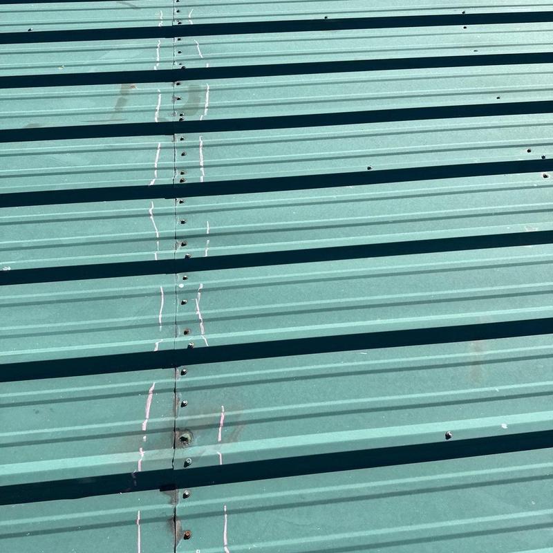 Metal roofing panels with hail damage marks