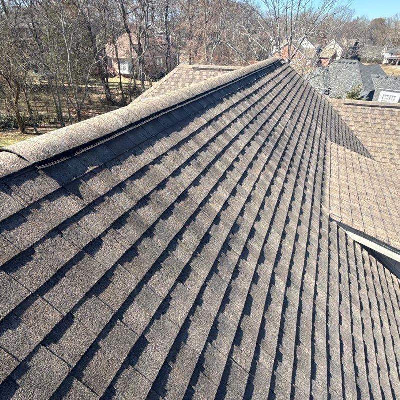 Asphalt shingle roof with ridge caps and flashing