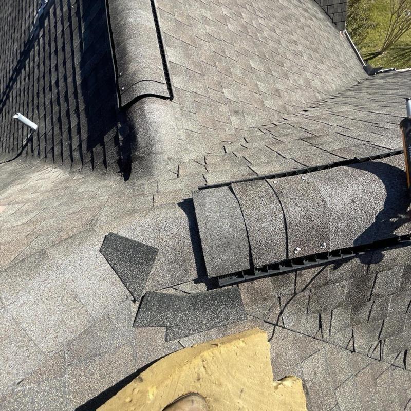 Architectural asphalt shingles and ridge vent repair on roof