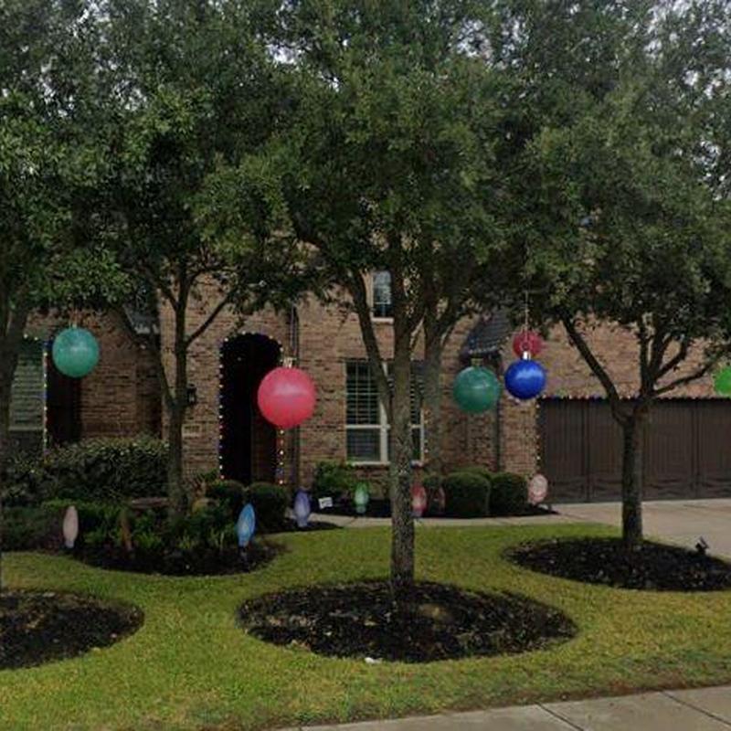 Roof with hanging colorful decorations in front yard