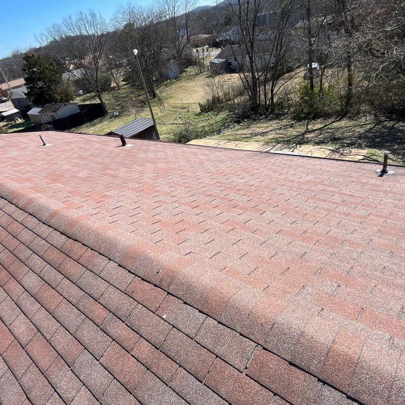 Asphalt shingle roof with vent pipes and ridge cap