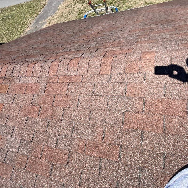 Asphalt shingles with hail damage on roof surface