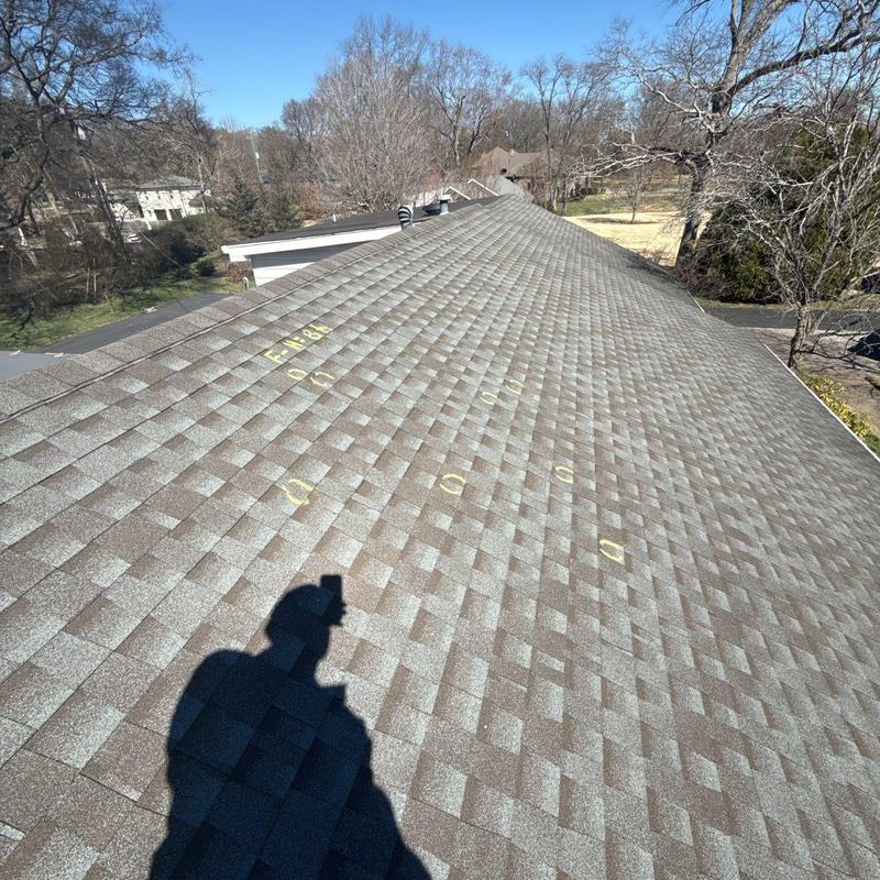 Asphalt shingle roof with marked hail damage spots