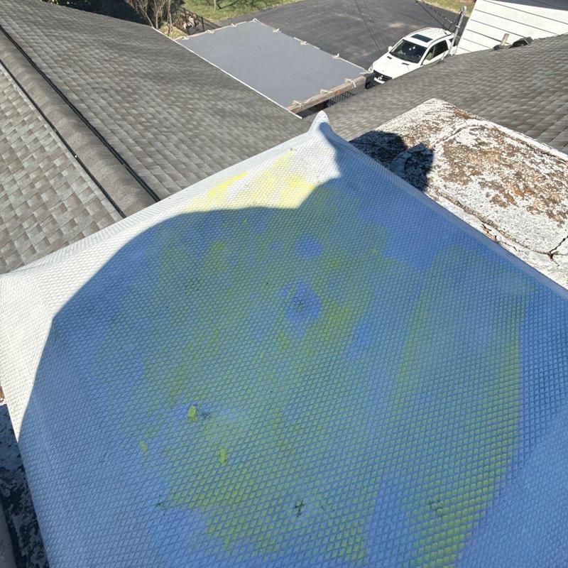 Roof ridge vent inspection with visible wear and discoloration