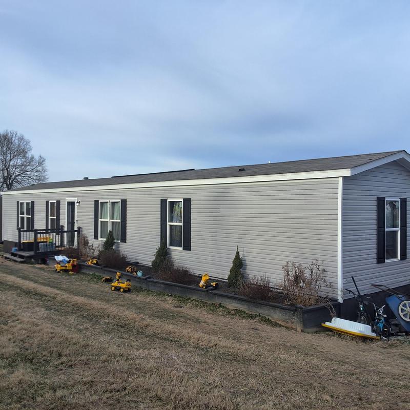 Roof shingles with wind and hail damage on mobile home