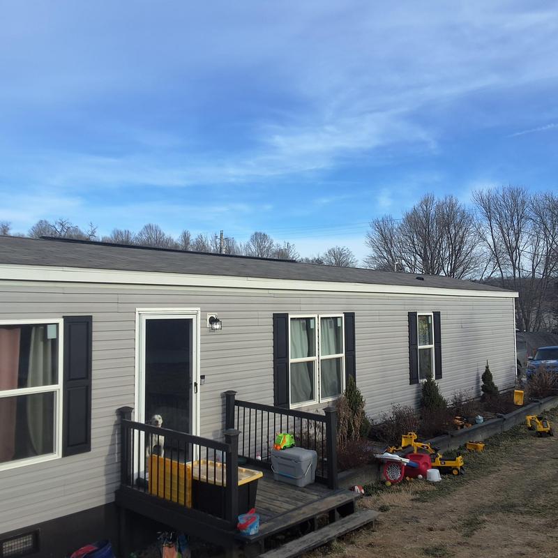 Roof shingles with visible wind and hail damage