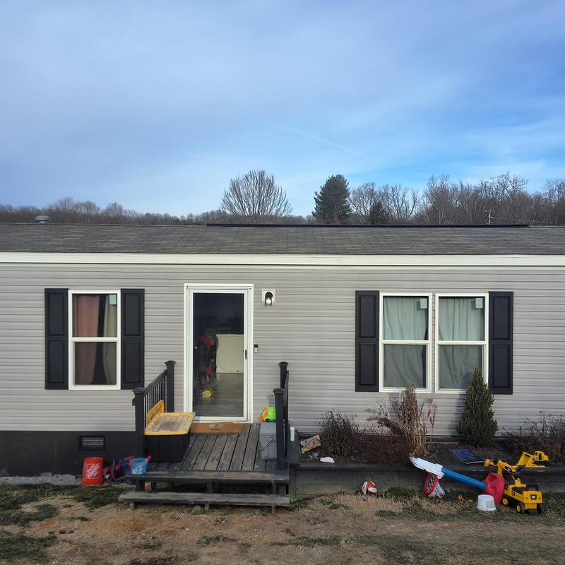 Mobile home roof with wind and hail damage