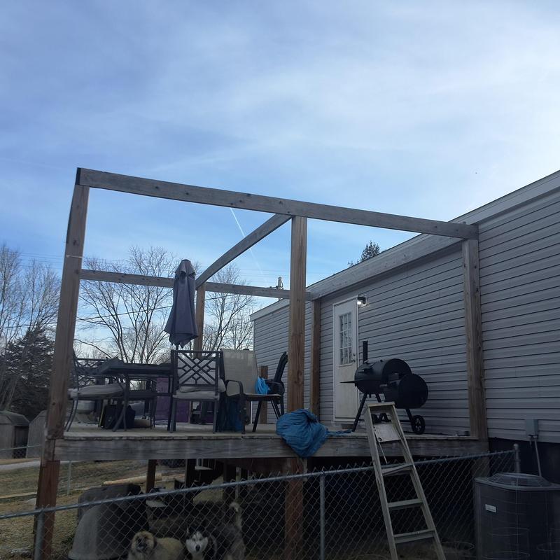 Deck framing and outdoor furniture on mobile home porch