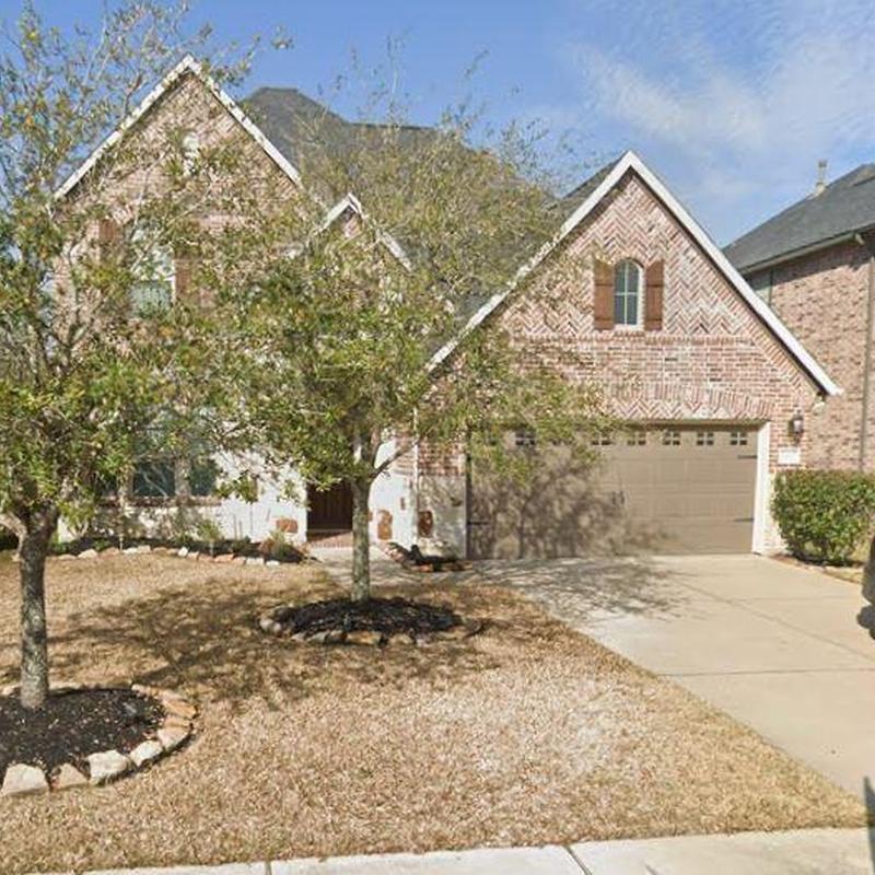 Roof and gutter inspection on brick house exterior