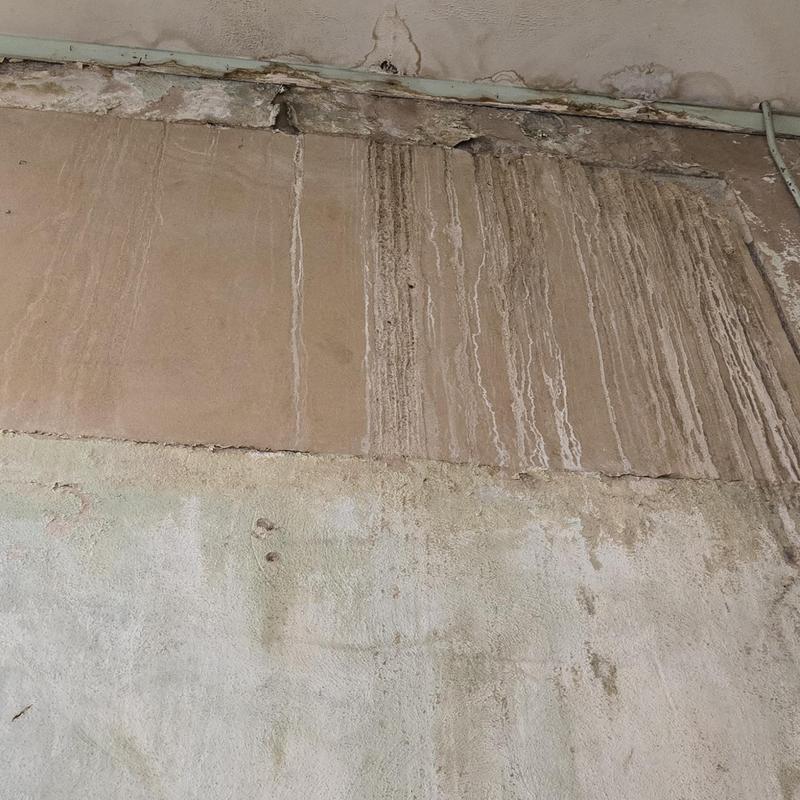 Wall water damage with streaks and cracks