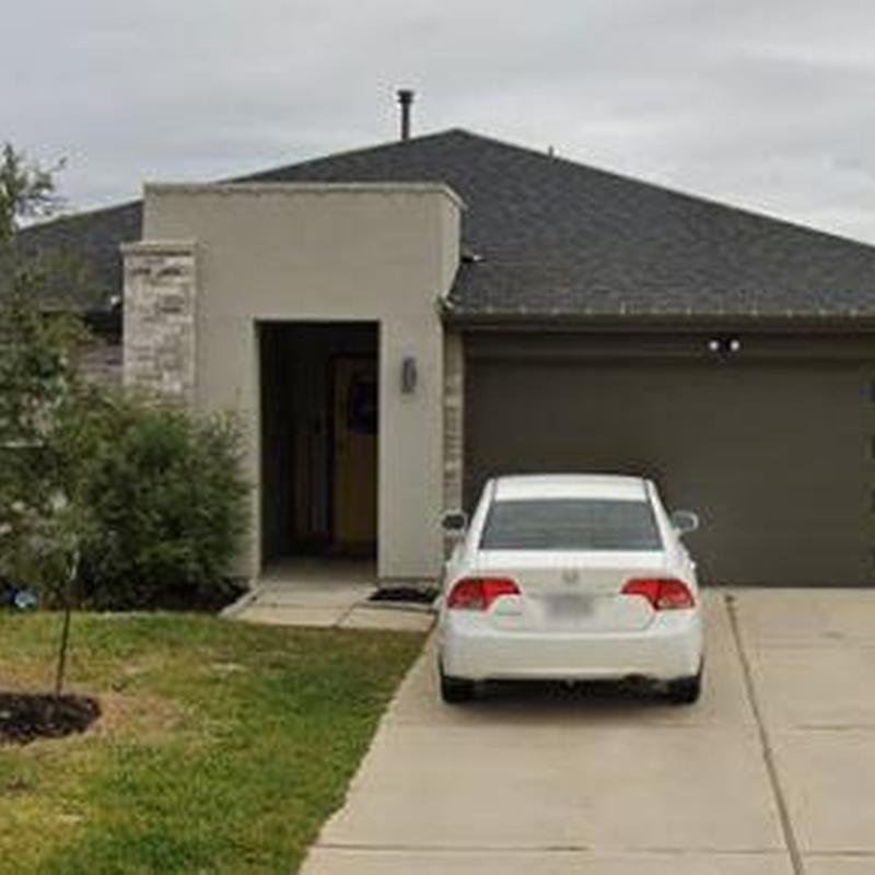 Asphalt shingle roof on suburban home with driveway