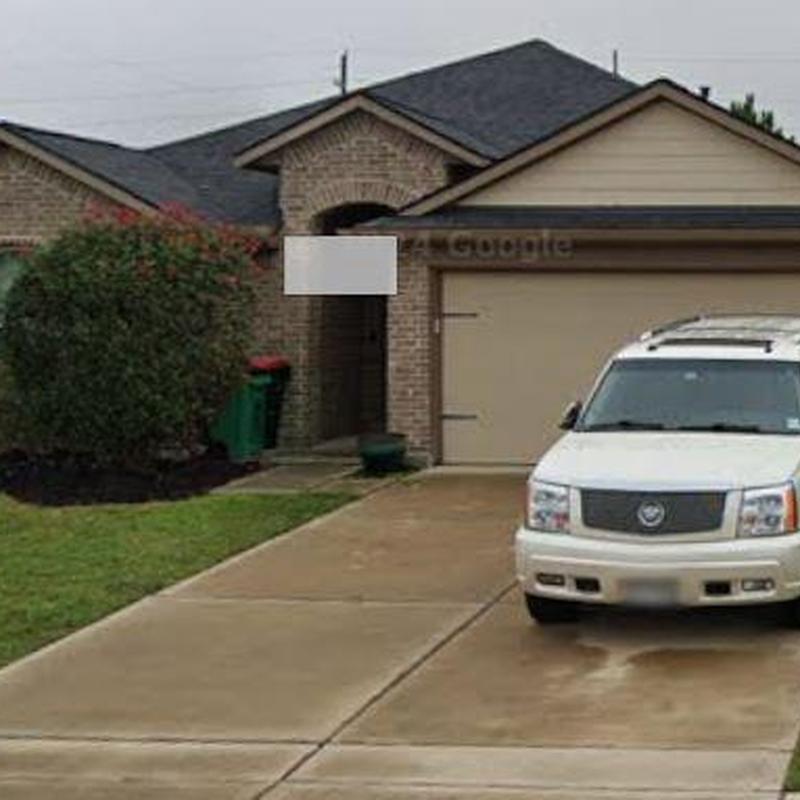 Asphalt shingle roof with driveway and white SUV