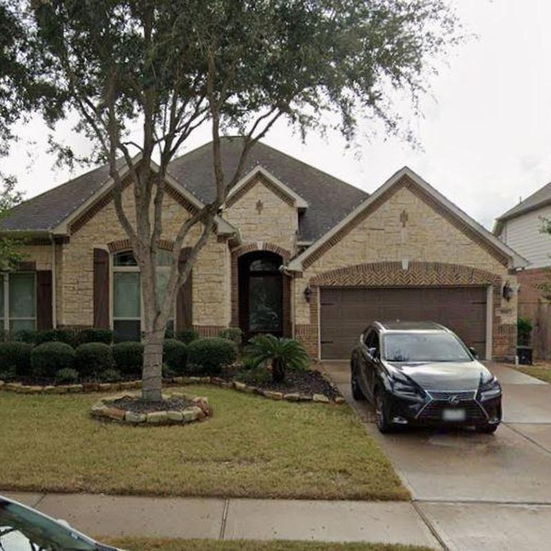 Roof shingles and gutters with tree maintenance in yard