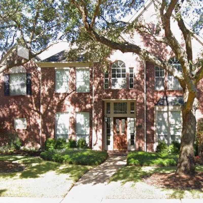 Brick exterior wall inspection with landscaping in front