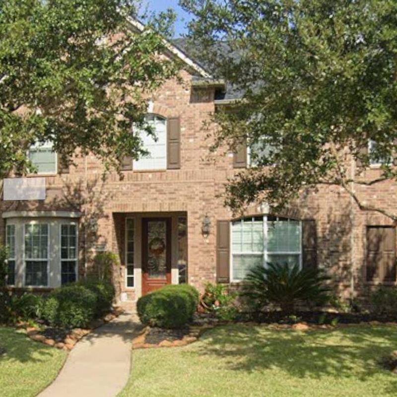 Brick house exterior with landscaping and pathway