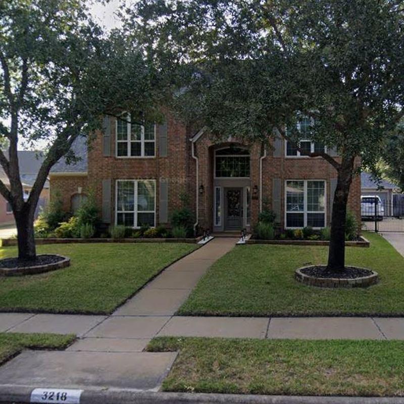 Residential roof exterior with healthy front lawn maintenance