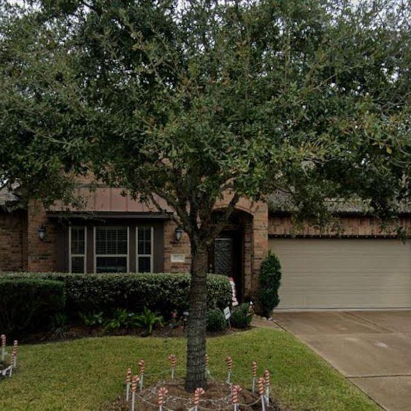Residential roofing and gutter system with front yard tree