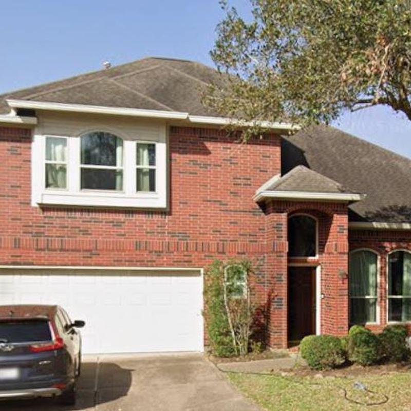 Asphalt shingle roof and brick exterior on residential house