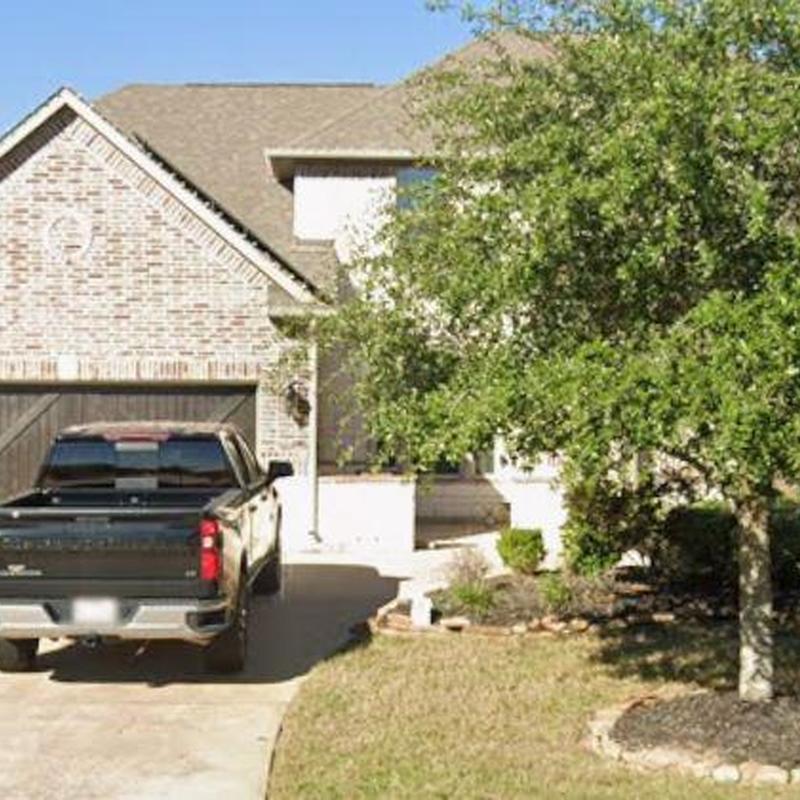 Roof shingles and gutter inspection near driveway in Katy TX