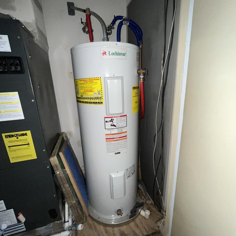 Electric water heater with red and blue pipes installation
