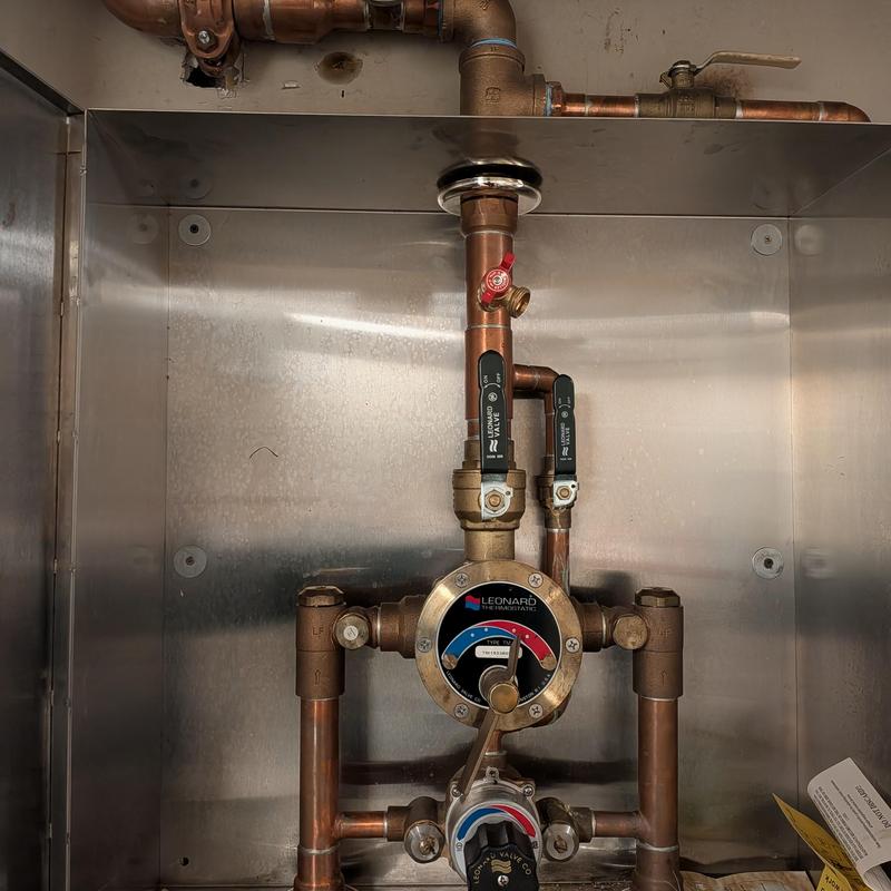 Mixing valve and copper piping in mechanical cabinet