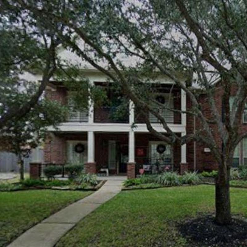 Residential roofing with tree-lined front yard in Katy, TX