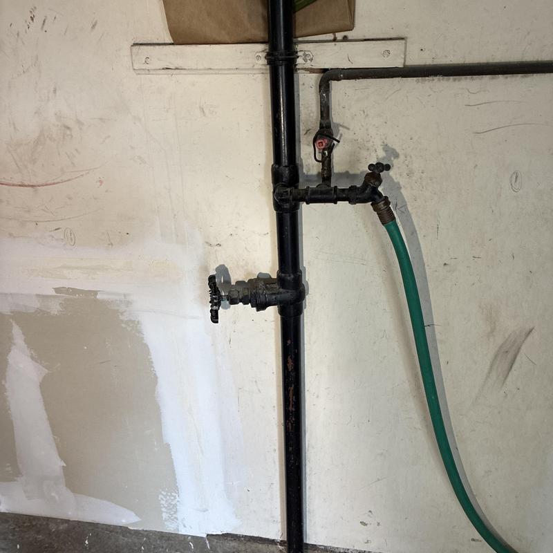 Outdoor water spigot and valve on black pipe system