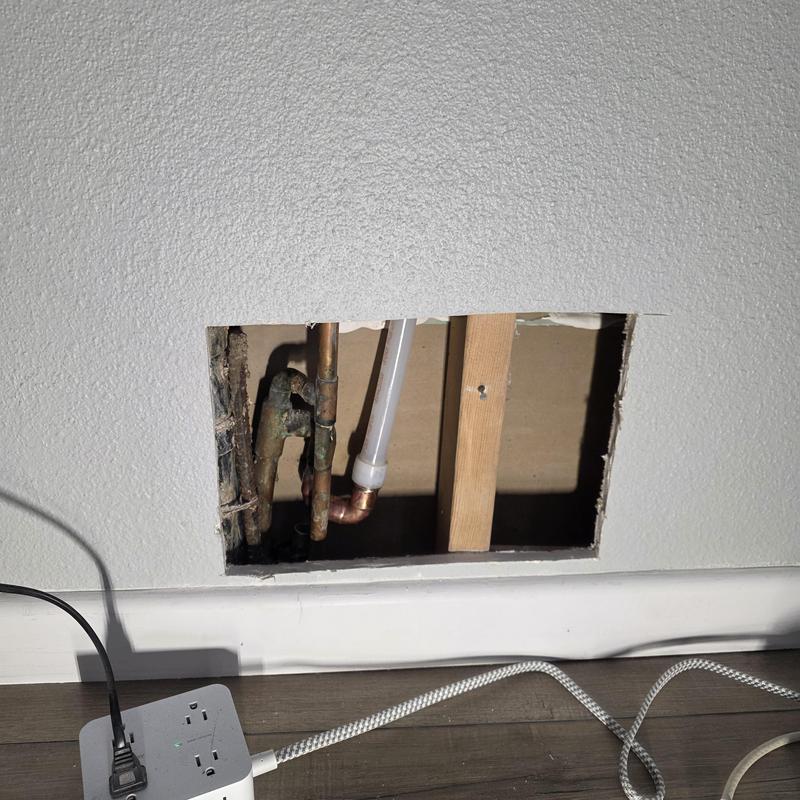 Hot water line with copper and pex piping in wall cavity