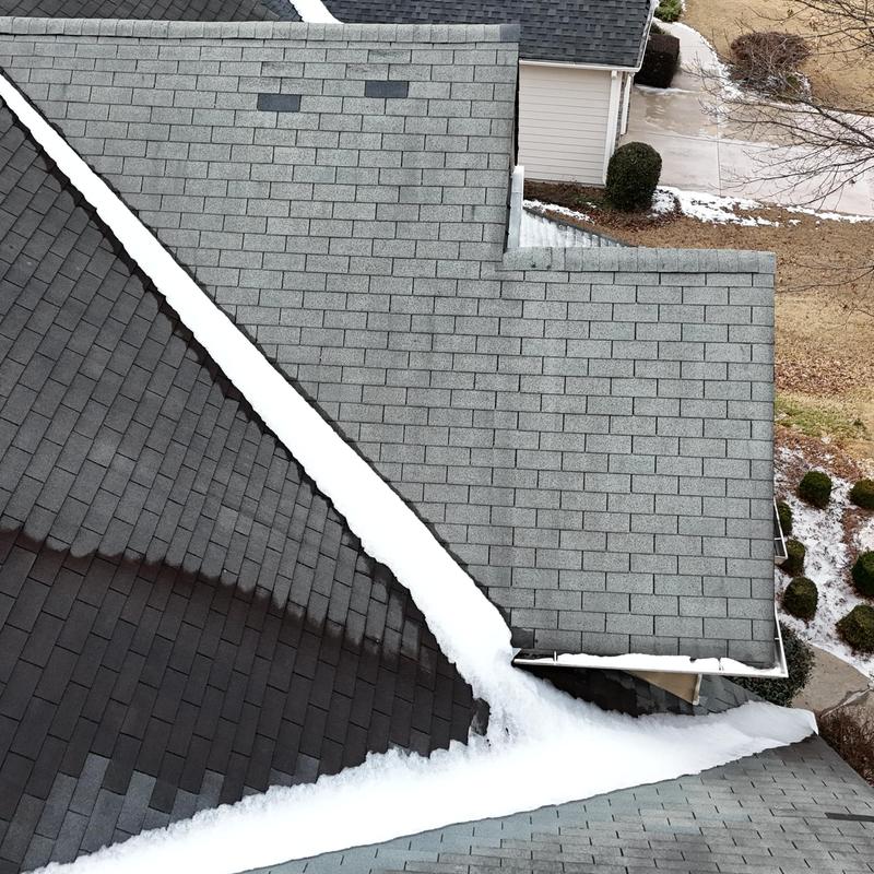 Faded slate shingles missing on three-story roof