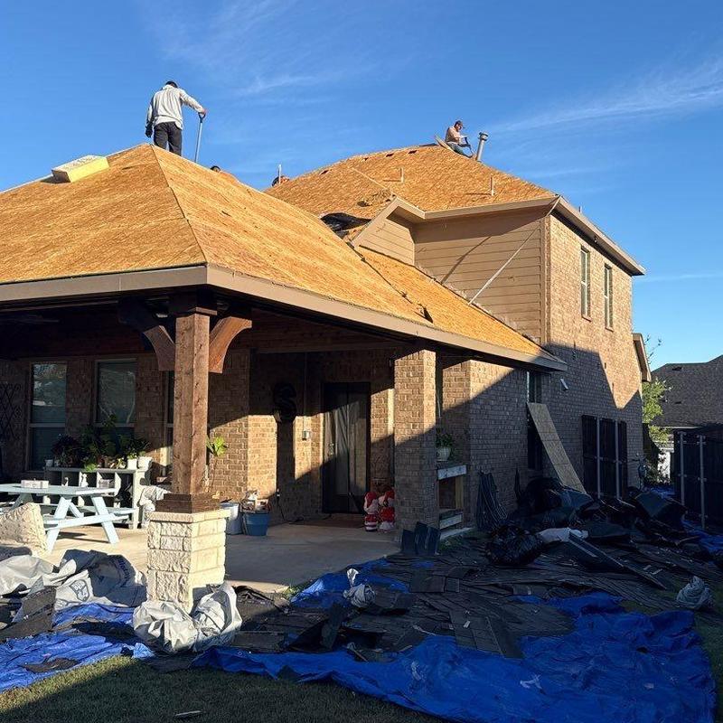 Roof decking replacement with workers on a residential home