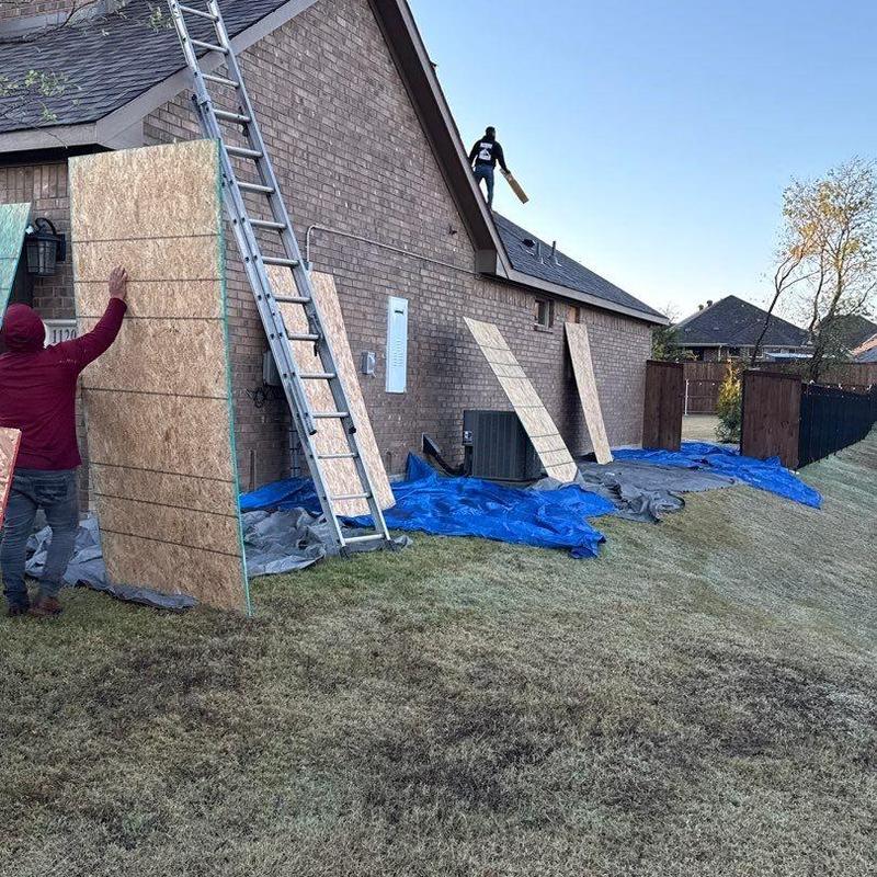 Roof sheathing installation with ladder and plywood panels