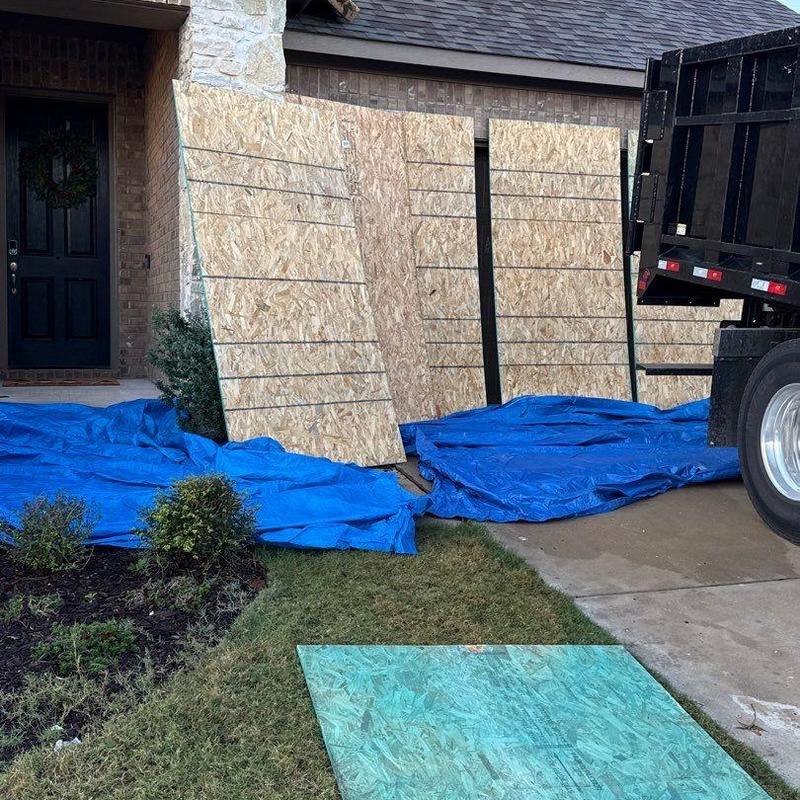 OSB plywood panels staged for exterior wall repair