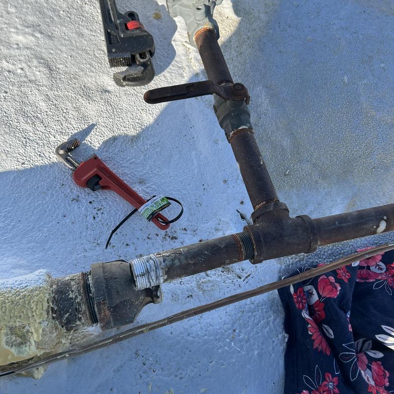 1 inch gas line with coupling on roof, tools nearby