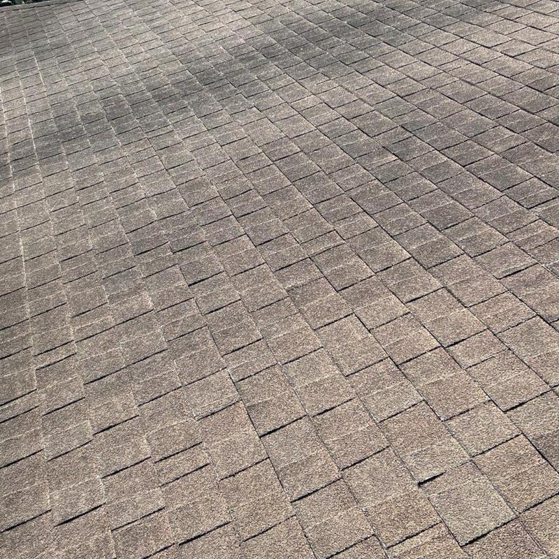 Asphalt shingle roof surface with visible wear and gaps