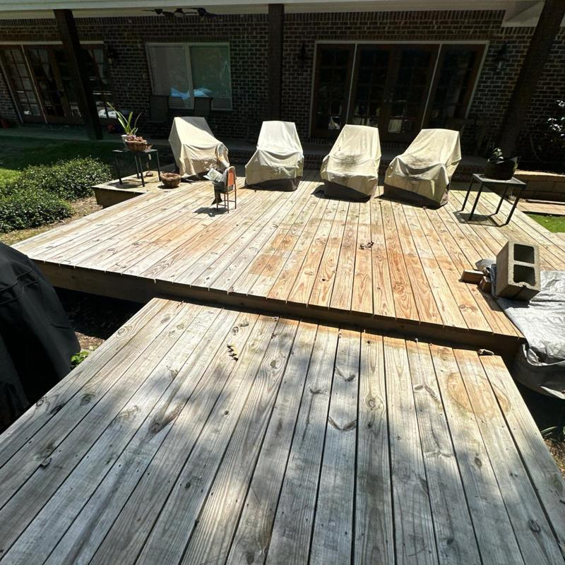 Wooden back deck with covered patio furniture Wooden back deck with covered patio furniture