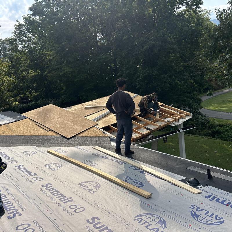 Roof decking installation with plywood sheets and underlayment