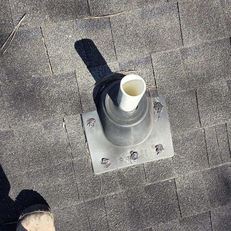 Roof vent flashing with caulked fasteners on asphalt shingles