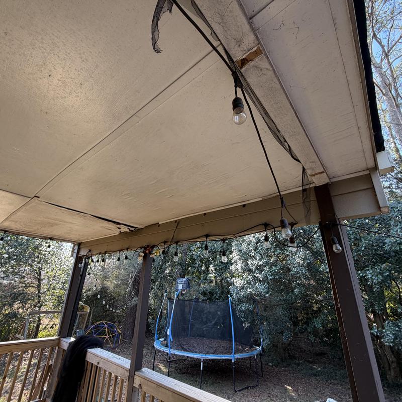 Porch ceiling plywood and trim with damage visible