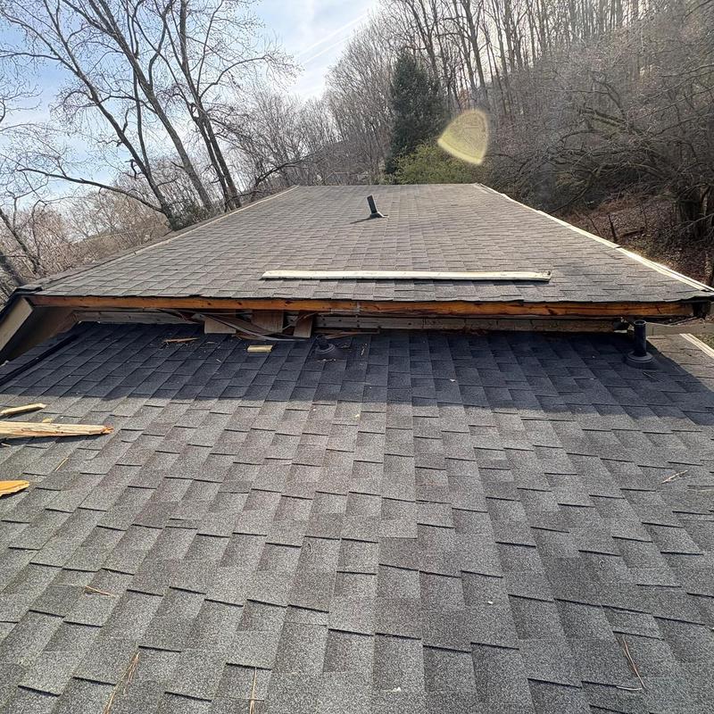 Soffit and fascia showing damage above roof shingles