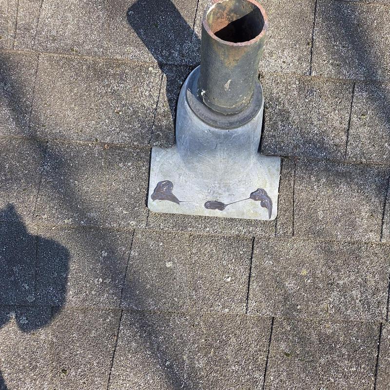 Pipe boot with sealant on asphalt shingle roof