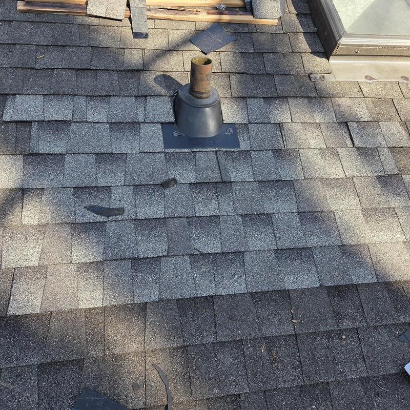 Pipe boot and asphalt shingle roof with new decking