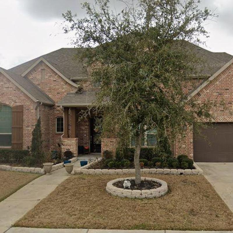 Roof shingles and brick exterior with front yard tree