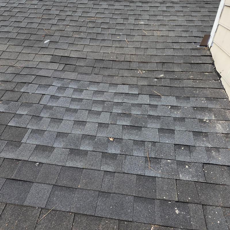 Roof shingles with patched damaged decking and chimney flashing