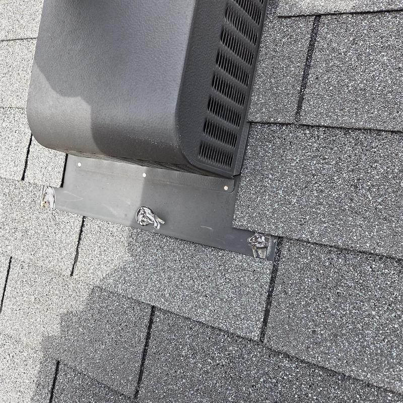 Roof shingles and vent flashing with caulked seals