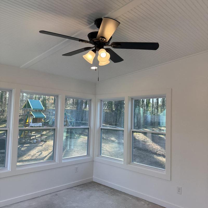 Enclosed patio with ceiling fan and windows