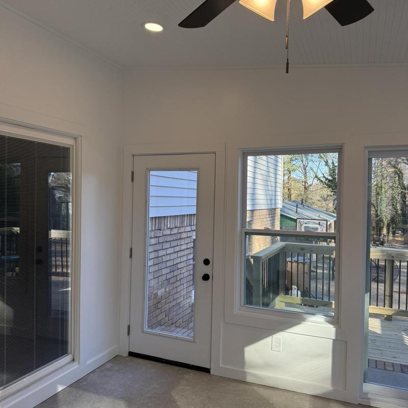 Enclosed patio interior with door and windows