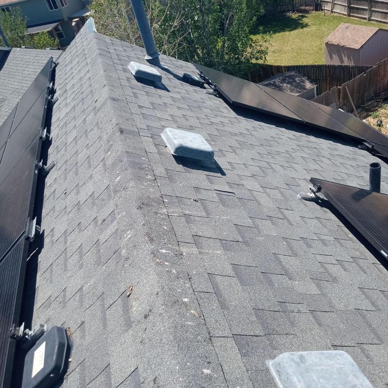 Roof shingles with hail damage and solar panels Roof shingles with hail damage and solar panels
