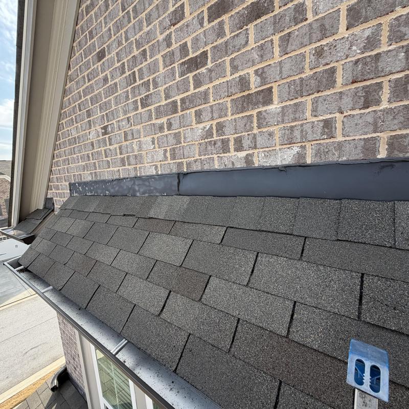 Roof flashing on 10 wall with shingle roof inspection