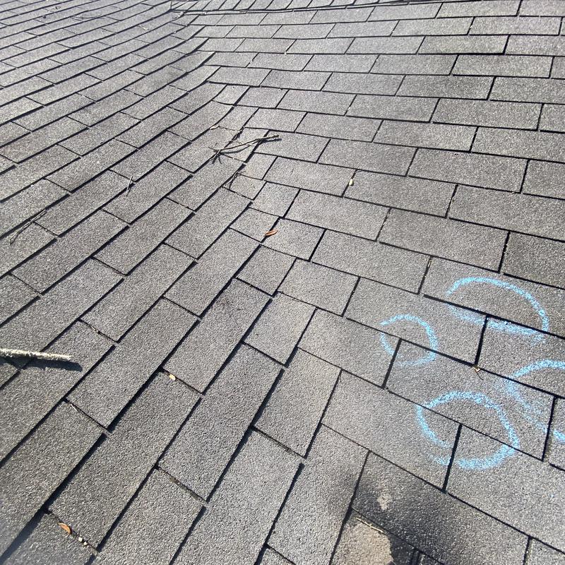 Asphalt shingle roof with chalked damage markings Asphalt shingle roof with chalked damage markings